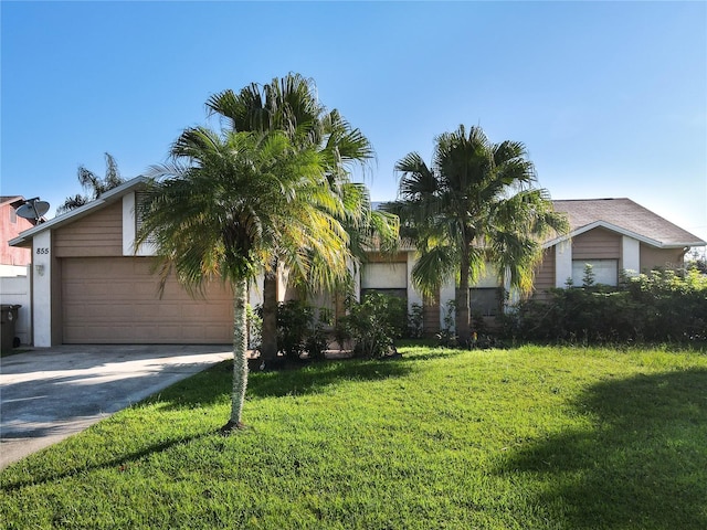 view of front of house with a garage and a front lawn