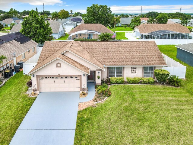 single story home with a front yard and a garage