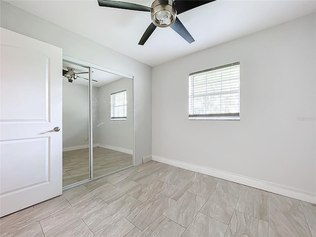 unfurnished bedroom featuring a closet, ceiling fan, and baseboards