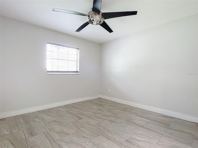 empty room featuring baseboards and ceiling fan