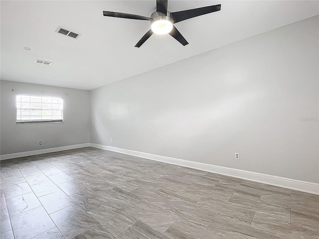 spare room with visible vents, baseboards, and ceiling fan