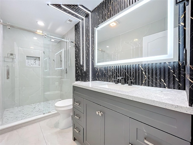 full bathroom featuring visible vents, toilet, marble finish floor, a shower stall, and vanity