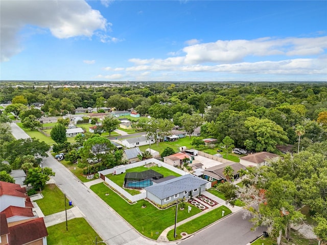 birds eye view of property featuring a view of trees