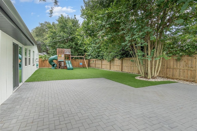 view of patio / terrace with a playground and a fenced backyard