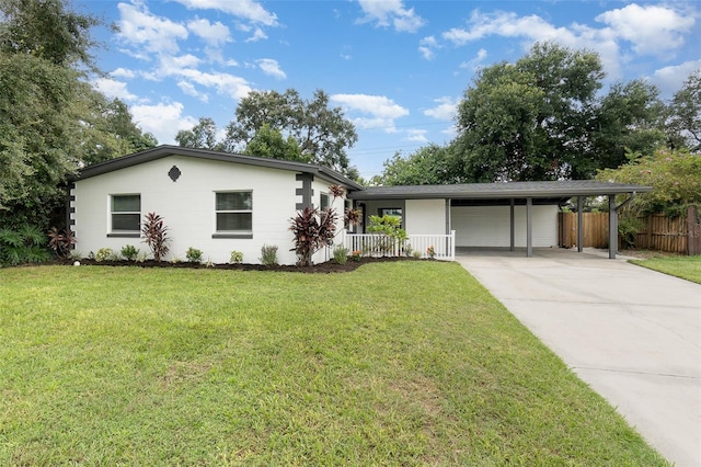 ranch-style home featuring a carport, fence, driveway, and a front lawn