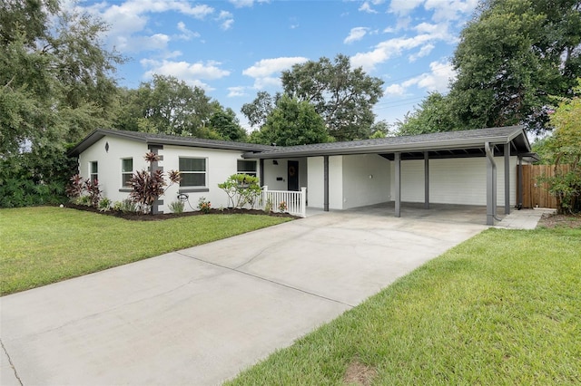 ranch-style house featuring a carport, a garage, and a front yard