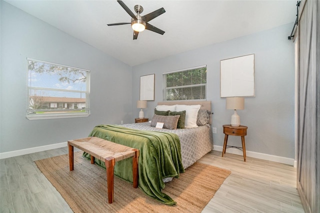 bedroom featuring lofted ceiling, ceiling fan, light wood-type flooring, and baseboards