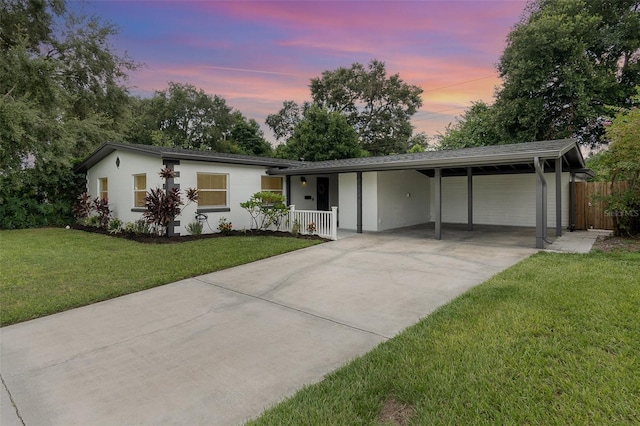 single story home with driveway, fence, and a front yard