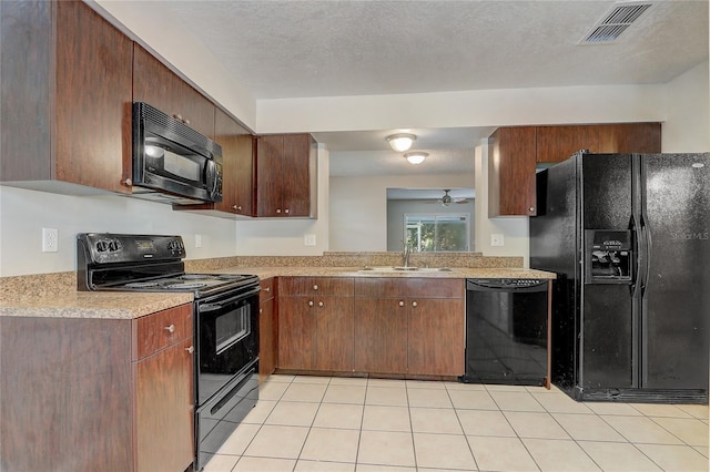 kitchen with black appliances, visible vents, light countertops, and a sink