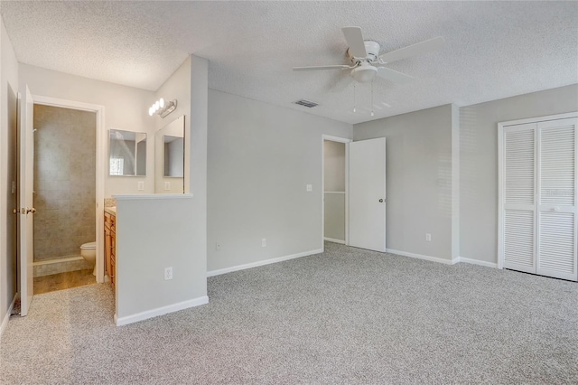 unfurnished bedroom with a closet, light colored carpet, visible vents, and baseboards