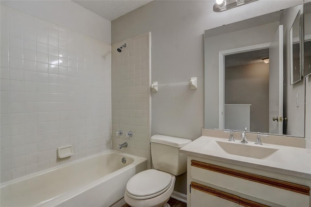 bathroom with  shower combination, vanity, and toilet