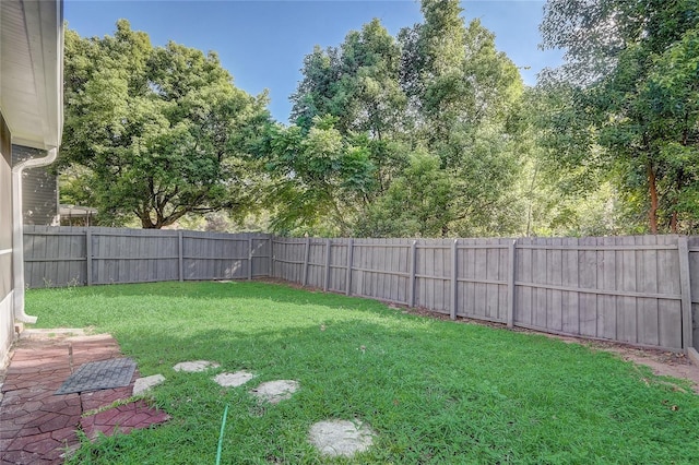 view of yard with a fenced backyard