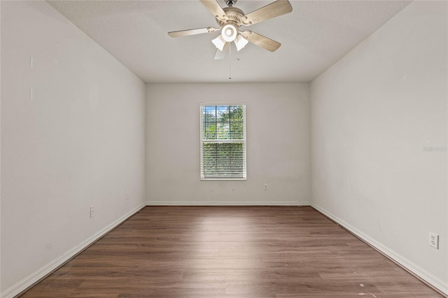 empty room featuring ceiling fan and hardwood / wood-style floors