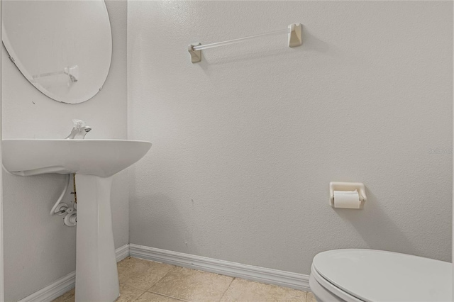 bathroom featuring tile patterned floors and toilet