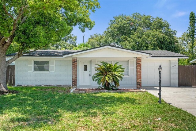 single story home featuring a garage and a front yard