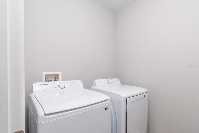 clothes washing area featuring washer and dryer and laundry area