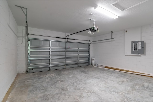 garage featuring electric panel, a garage door opener, and concrete block wall