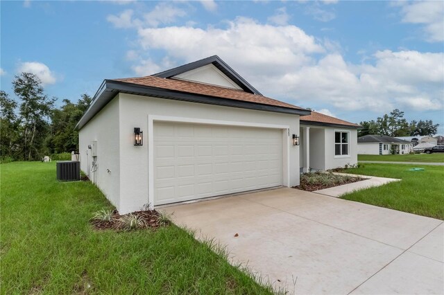 view of home's exterior with stucco siding, a garage, central AC, and a yard
