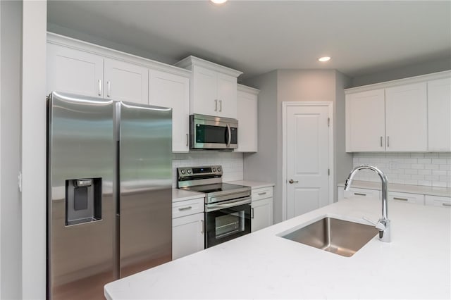 kitchen featuring light countertops, a sink, and stainless steel appliances