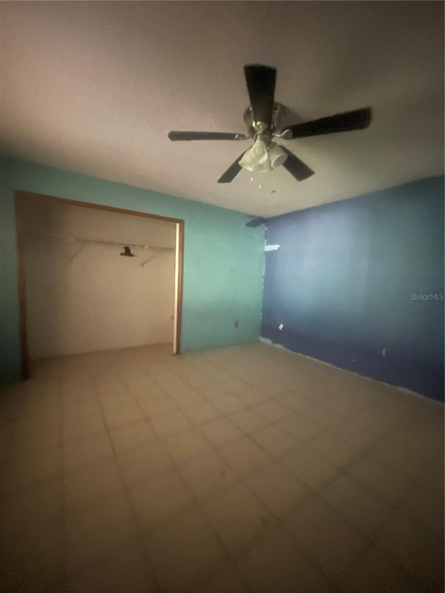 unfurnished room featuring ceiling fan and tile patterned flooring