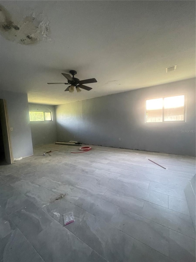 unfurnished room with ceiling fan