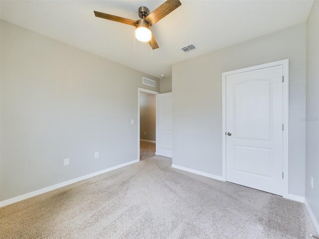 1502 Jadewood Way, Kissimmee, FL 34744 - unfurnished bedroom with light carpet, baseboards, visible vents, and ceiling fan