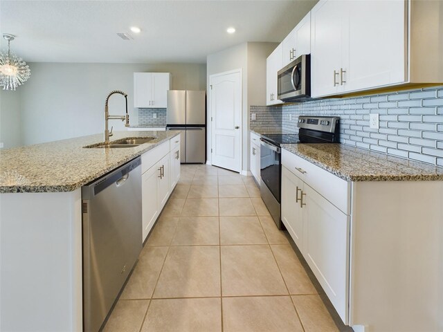 1502 Jadewood Way, Kissimmee, FL 34744 - kitchen with white cabinetry, a center island with sink, appliances with stainless steel finishes, and a sink