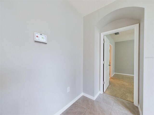 1502 Jadewood Way, Kissimmee, FL 34744 - corridor featuring light colored carpet, visible vents, baseboards, and light tile patterned floors