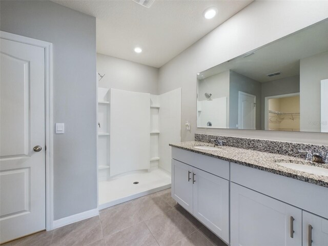 1502 Jadewood Way, Kissimmee, FL 34744 - full bath with a stall shower, visible vents, and a sink