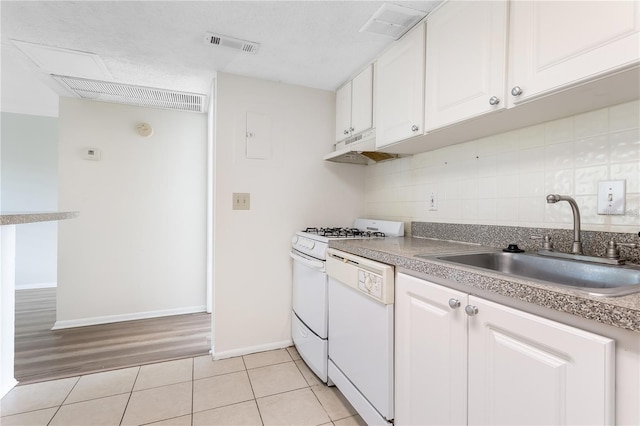 kitchen featuring backsplash, light hardwood / wood-style flooring, sink, range, and white cabinets