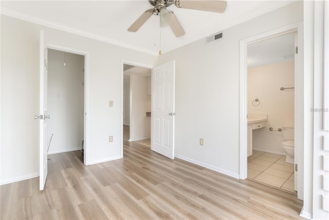 unfurnished bedroom featuring ceiling fan, connected bathroom, crown molding, and light wood-type flooring