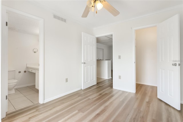 unfurnished bedroom featuring ensuite bathroom, ornamental molding, ceiling fan, and light hardwood / wood-style floors