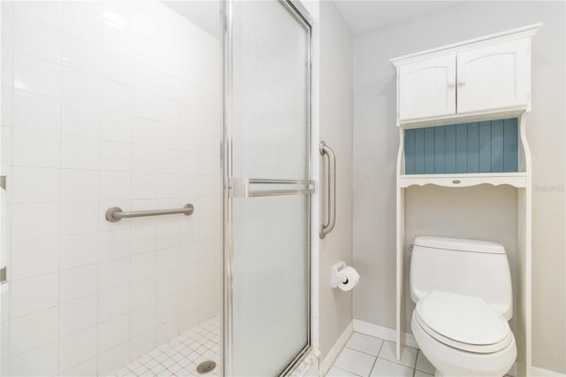 bathroom featuring tile patterned floors, an enclosed shower, and toilet