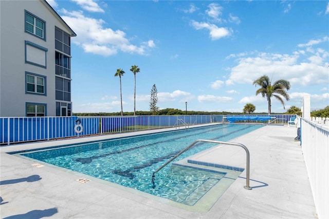 pool featuring a patio area and fence