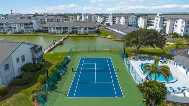 exterior space with a community pool and a water view