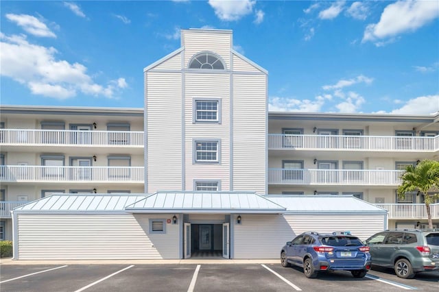 view of building exterior with uncovered parking