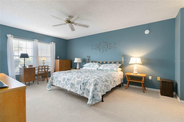 bedroom featuring a textured ceiling, carpet floors, and ceiling fan