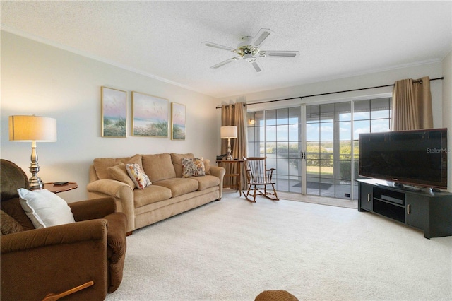 carpeted living room featuring a textured ceiling, ceiling fan, and ornamental molding