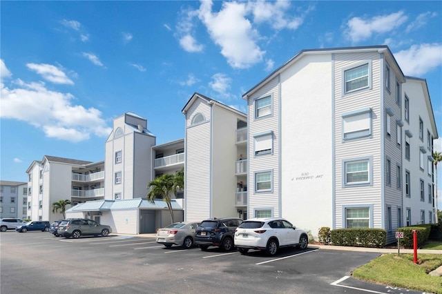 view of building exterior featuring uncovered parking