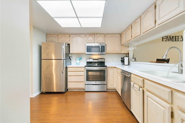 kitchen featuring light hardwood / wood-style floors, appliances with stainless steel finishes, sink, and light brown cabinets