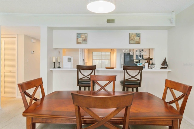 dining space featuring ornamental molding