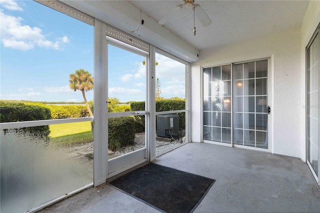 unfurnished sunroom with ceiling fan