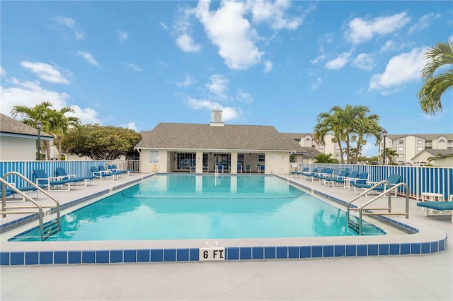 community pool featuring a patio and fence