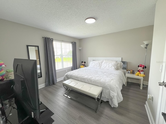 bedroom featuring dark hardwood / wood-style floors and a textured ceiling