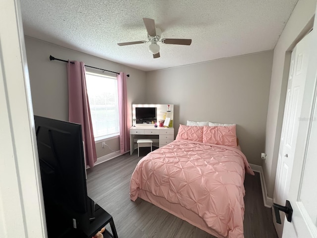 bedroom with ceiling fan, a closet, a textured ceiling, and wood-type flooring