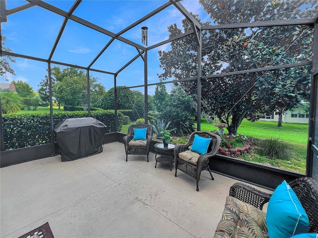 view of patio featuring area for grilling and glass enclosure