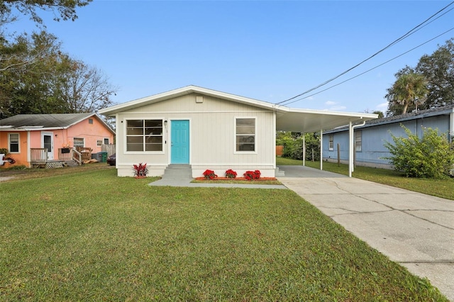 view of front of home with a front lawn and a carport