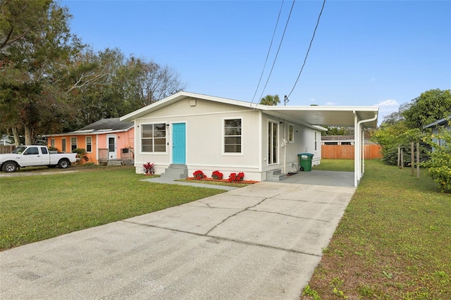 view of front of property with a front lawn and a carport