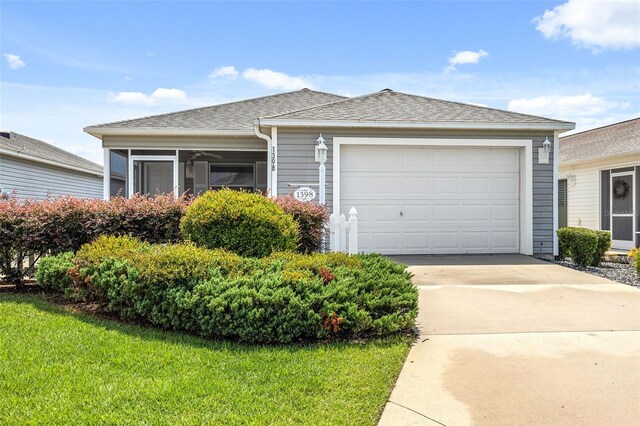 view of front of property featuring a garage and a front yard