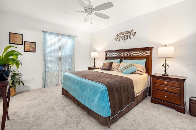 bedroom with ceiling fan and light colored carpet